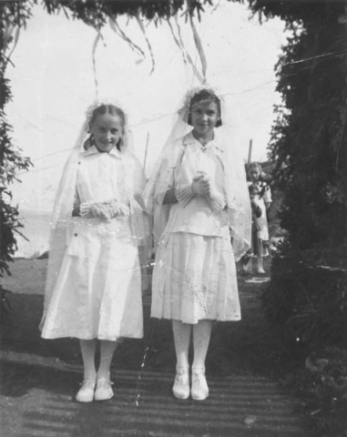 020: Written on the back of the photo "Confirmation day. Mary Reddy and Mary Ennis taken the day we were confirmed by his excellency most Rev. Patrick James Skinner. He is a lovely Bishop". l-r Mary Ennis, Mary Reddy, Babe Ennis (background). The girls are standing under the bishop's arch. (1950) [courtesy of Mary (Reddy) King]- Mary daughter of Michael Reddy &amp;amp; Elizabeth Moore; Mary and Babe daughters of Vincent Ennis &amp;amp; Min Carroll.